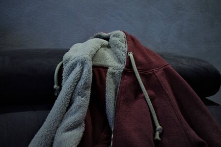 Isolated sweater with fur and with hood on the sofa (Pesaro, Italy, Europe)の写真素材
