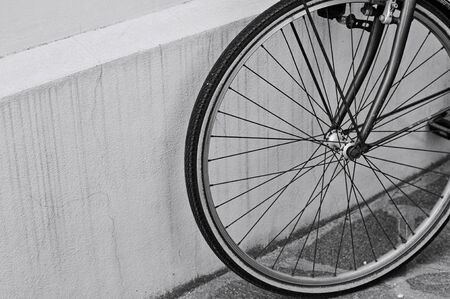 Bike wheel against the wall of an old ruined bike (Pesaro, Italy, Europe)の写真素材