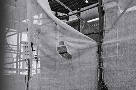 A broken scaffolding protection net in a building site (Pesaro, Marche, Italy)