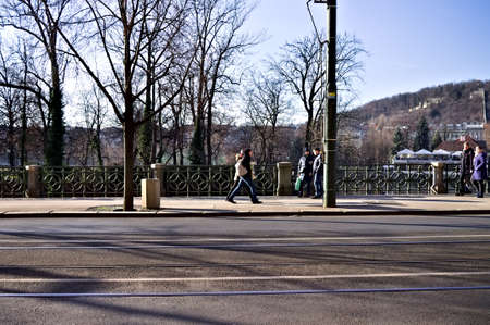 Prague, Czech Republic - 30 December 2019: people walking on a sidewalk near an asphalted roadのeditorial素材