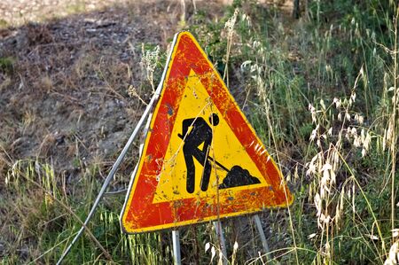 Triangular traffic sign which indicates work in progress on the road (Pesaro, Italy, Europe)の写真素材