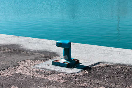 Blue mooring bollard on the jetty of a commercial dock (Pesaro, Italy, Europe)の写真素材