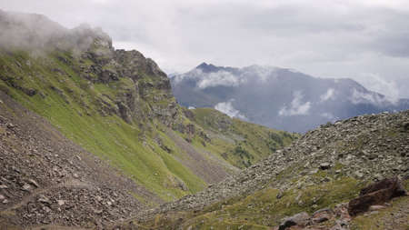 A desertic valley in the Alps under the mountains in a foggy day (Peio, Trentino, Italy, Europe)の写真素材