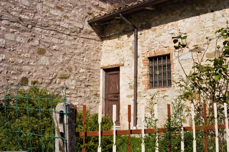The entrance of an old rural house with a ruined wooden door (Gubbio, Umbria, Italy)のeditorial素材