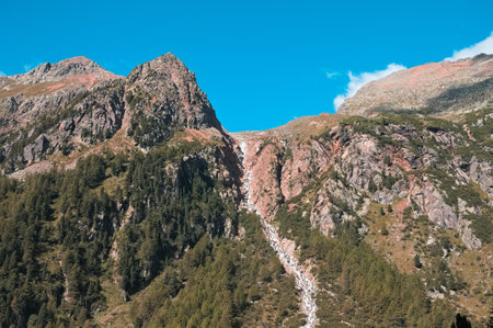 An isolated waterfall on the top of a mountain (Alps, Trentino, Italy)の写真素材