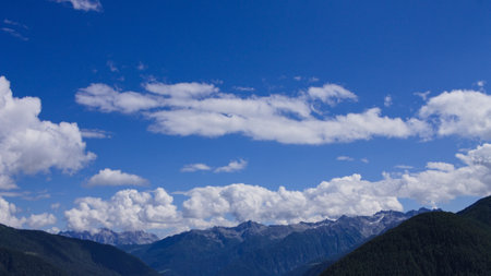 A mountain landscape with clouds in the sky on a summer day in the Italian Alps (Trentino, Italy, Europe)の写真素材
