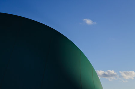 Clouds in the sky behind a pressure switch structure with a plastic cover of a sports building (Pesaro, Italy, Europe)の写真素材