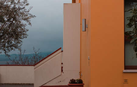 The facade of a yellow house with concrete stairs (Pesaro, Italy, Europe)の写真素材
