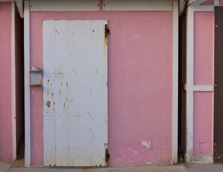 A white wooden door of a pink beach hut (Pesaro, Italy, Europe)の写真素材