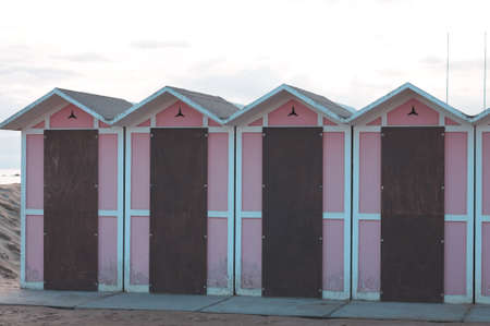 A set of pink beach huts with a wooden door in a bathhouse (Pesaro, Italy, Europe)の写真素材