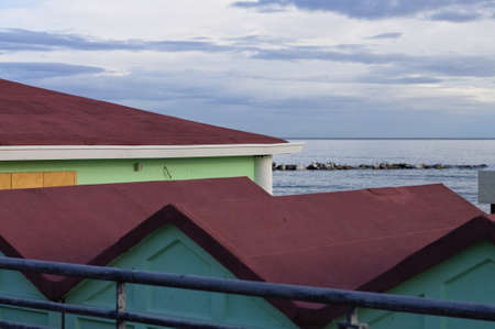 Colored beach huts on the sand in front of the Mediterranean Sea on a winter day (Pesaro, Italy, Europe)の写真素材