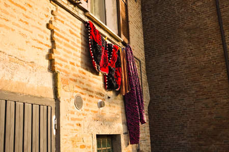 Medieval clothes hanging out the window in a medieval villageの写真素材