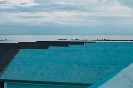 A series of blue beach huts on the Mediterranean coast in the evening hours (Pesaro, Marche, Italy)の写真素材