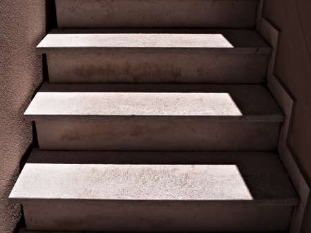 Shadows and lights on a concrete staircaseの写真素材
