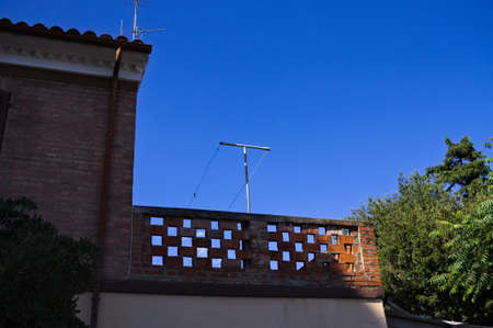 A brick balcony with an empty clothesline (Marche, Italy, Europe)の写真素材