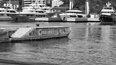 An isolated mooring bollard on the pier of the port of Pesaro with concrete stairs leading to the sea (Marche, Italy, Europe)の写真素材