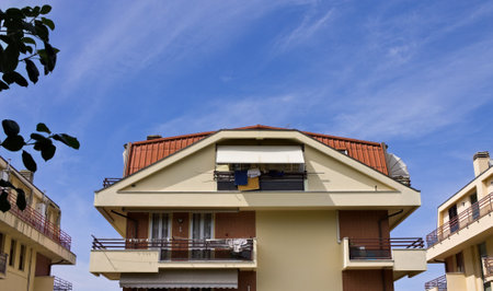 Italian residential building with prismatic roof finished with tiles and balconies (Marche, Italy, Europe)の写真素材