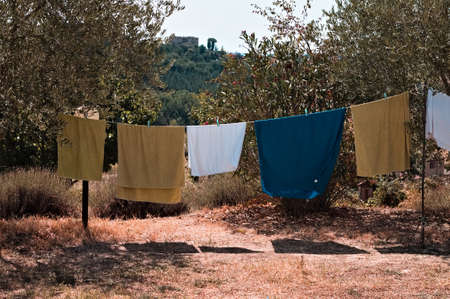 Towels and clothes hanging out to dry in the garden of a farm in the Italian countryside (Tuscany, Italy, Europe)の写真素材