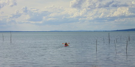 Two girls are canoeing on the Trasimeno lake (Umbria, Italy, Europe)の写真素材