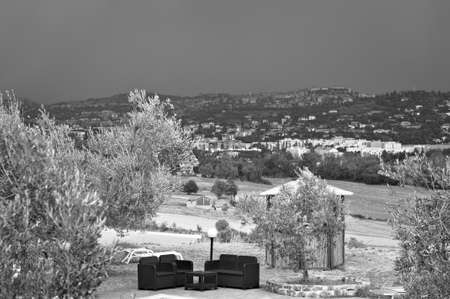 A pair of poolside sofas in the Italian countryside during a stormy day (Tuscany, Italy, Europe)の写真素材
