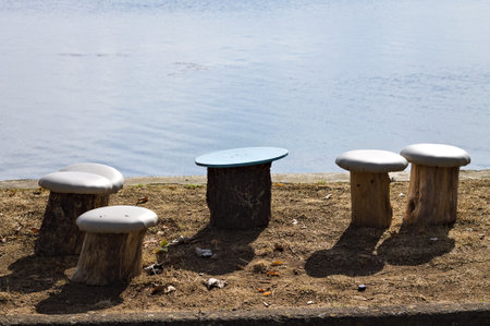Mushroom-shaped seats made from wood logs along the shore of Lake Trasimeno (Umbria, Italy, Europe)の写真素材