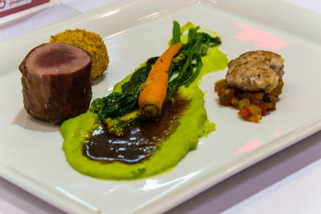 grille pork tenderlion serve asparagus puree mince pork and baby carrot variety of taste and texture food stylish and frence cuisineの写真素材