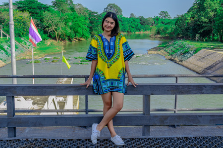 the girl smile and standing on Dam bridge in day time thailandの写真素材