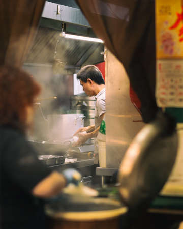 Unidentified people cooking in a restaurant in Taipei, Taiwan.の写真素材