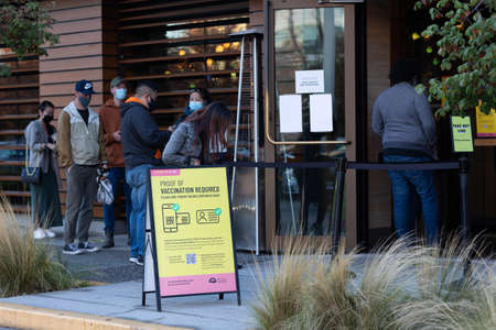 People queue at a coffee shop.の写真素材