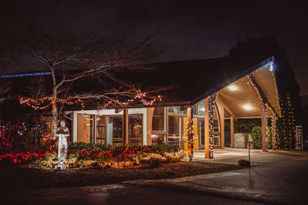 Night view of a house decorated with Christmas lights and garlands.の写真素材