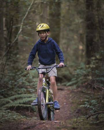 Cyclist Riding a Bike on a Trail in the Forest.の写真素材