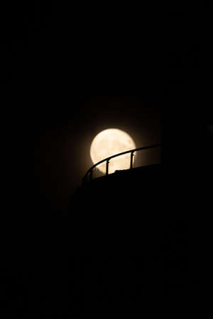 Full moon at night in the dark sky. Silhouette of a lantern.の写真素材