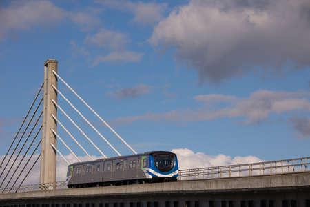 Railway train on the bridge with blue sky and clouds in the backgroundの写真素材