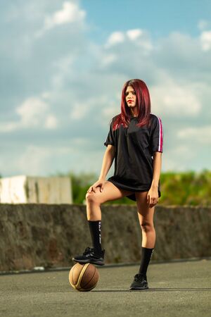 portrait of woman playing basketballの写真素材