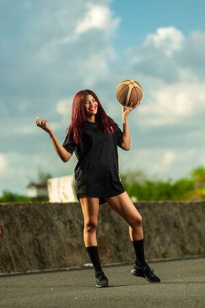 portrait of woman playing basketballの写真素材