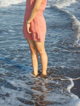 Young woman standing on the Beachの写真素材
