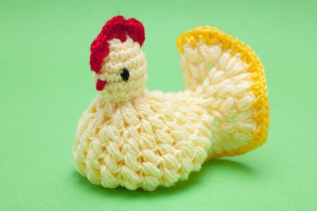Easter decorations - hand made yarn chicken on a green backgroundの写真素材