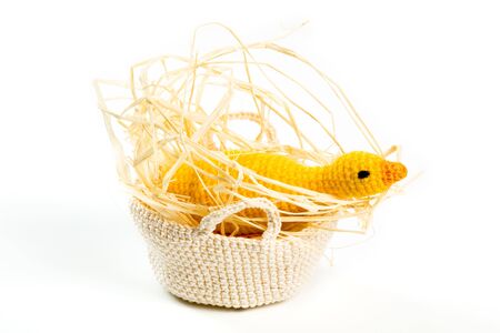 Easter decorations - yarn goose in nest on white backgroundの写真素材