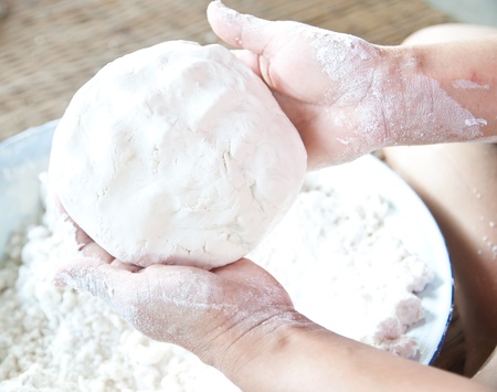 Close up of a woman kneading dough 