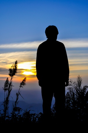 Silhouette of man on the sunsetの写真素材