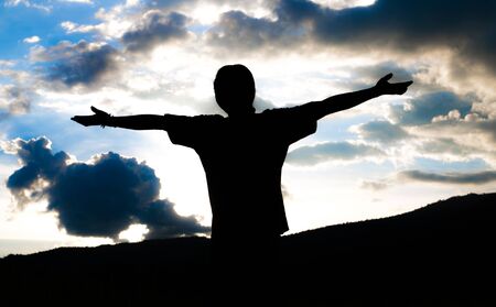 Happy man silhouette on the sunset の写真素材