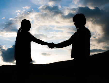 Two silhouette man shaking hands,nature concept の写真素材