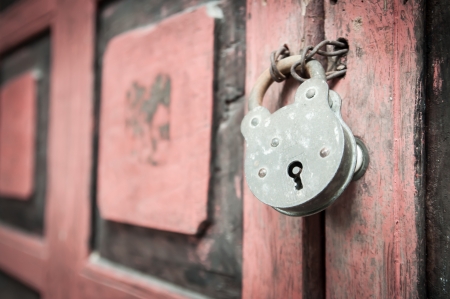 Old padlock on a wooden doorの写真素材