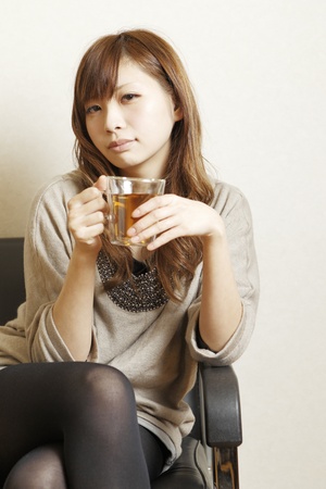 The woman who drinks tea の写真素材