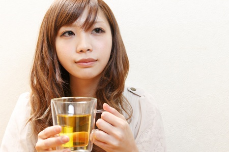 Woman enjoying tea  の写真素材