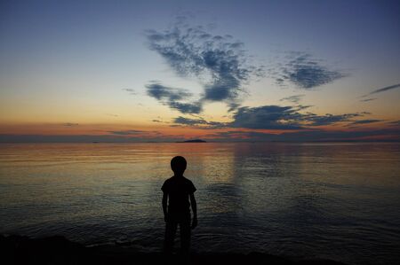 boy facing at sunsetの写真素材