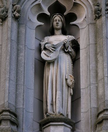Religious statue in stone on historic church.の写真素材