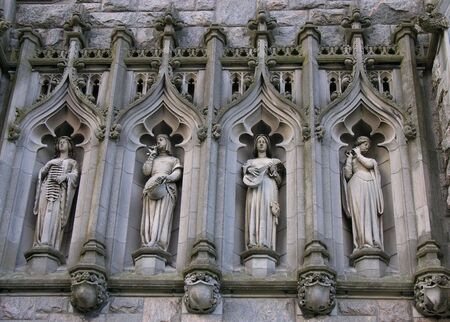 Carved images in stone on historic church.の写真素材