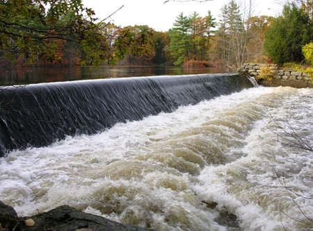 River and dam in fall.の写真素材