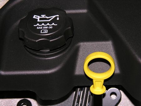 Engine oil dipstick and oil cap on a motor vehicle.の写真素材